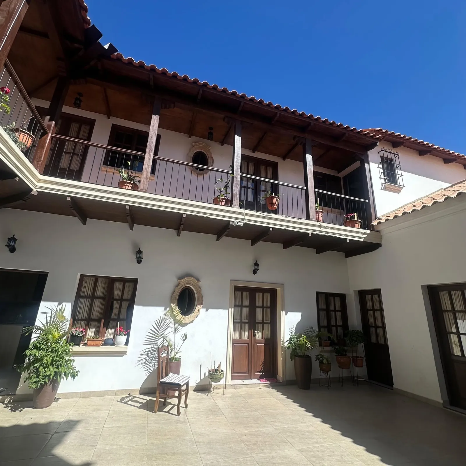 Patio colonial con balcones de madera y tejas en la Calle Azurduy